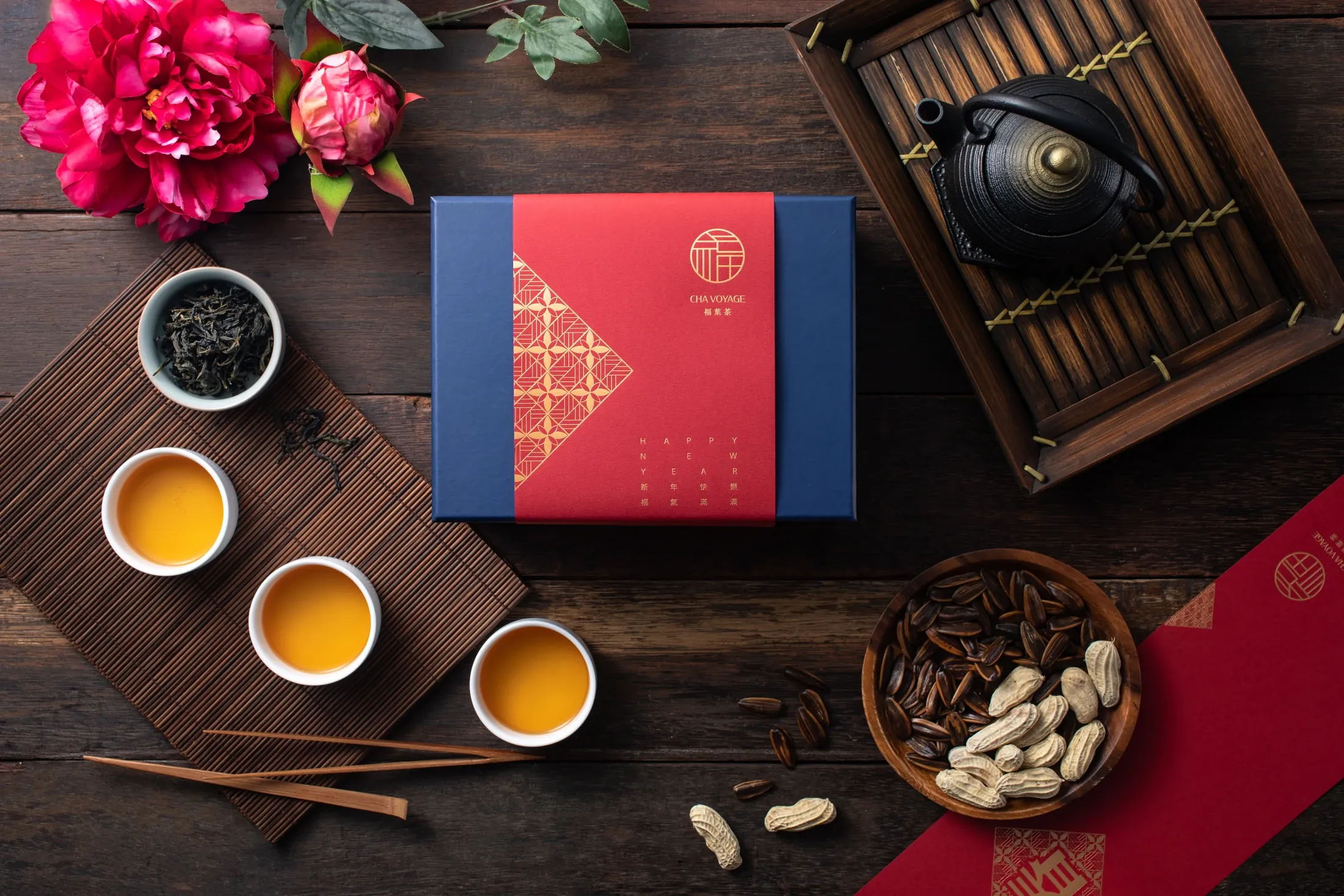 Cha Voyage gift boxes, brewed tea and whole-leaf tea on a tea table