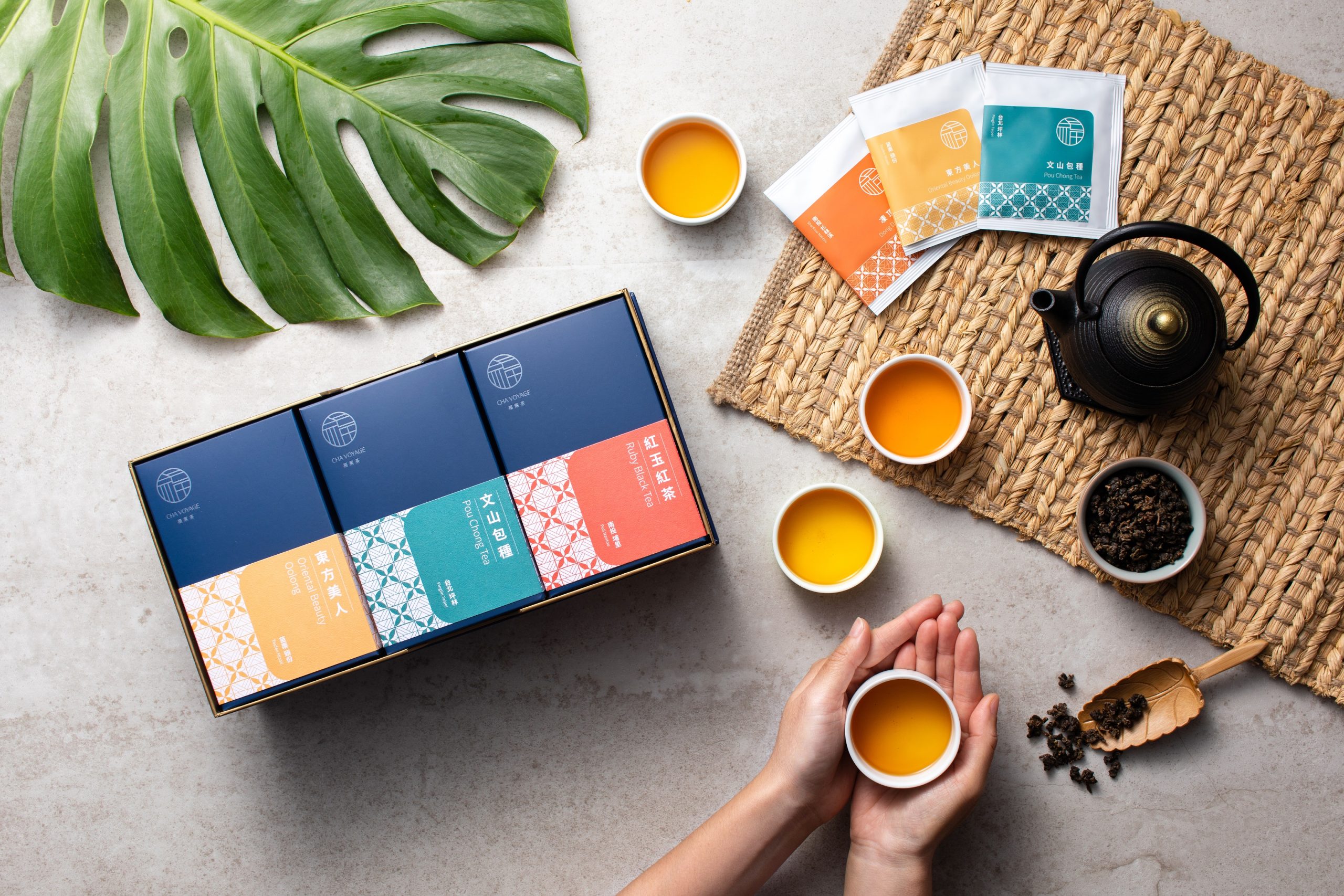 Cha Voyage tea table with a cup held in two hands